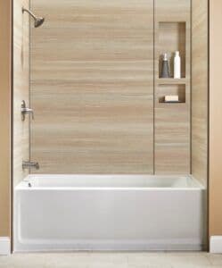 a new bathtub custom designed with tan colored wall and recessed shelving