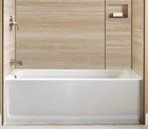 a newly installed tub with sand-colored surrounds and recess shelving