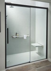 a remodeled shower with white walls, sliding doors, and shower chair