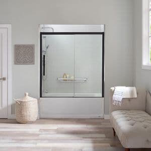 a remodeled bathtub with shelving, a showerhead, and sliding doors