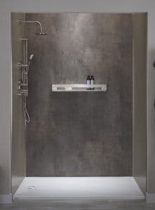 a newly remodeled shower with dark-toned walls, shelving, and a rainfall showerhead