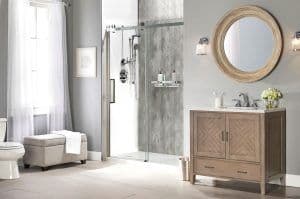 a remodeled shower with gray walls, shelving, and a rainfall showerhead